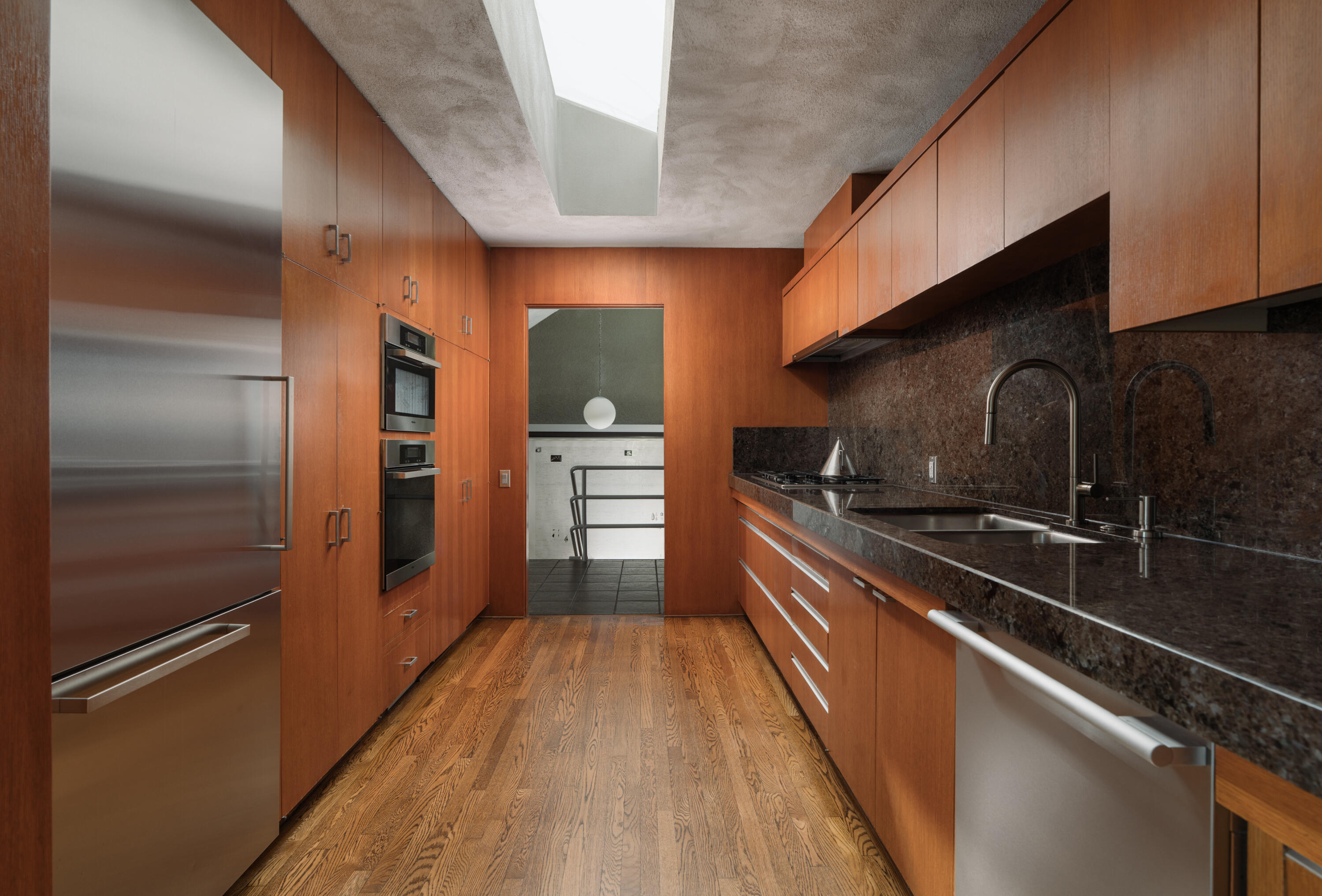 1944 Eucalyptus Hill Road Santa Barbara, CA 93108 - Photo 12 of 38 a kitchen with granite countertop stainless steel appliances and wooden cabinets