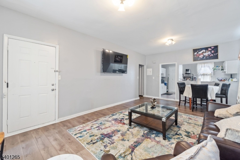 295 South 7th Street Newark, NJ 07103 - Photo 11 of 14 a living room with furniture and a flat screen tv