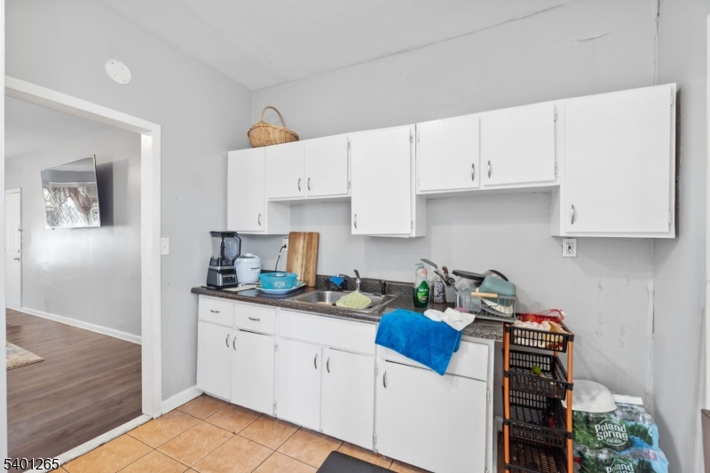 295 South 7th Street Newark, NJ 07103 - Photo 12 of 14 a kitchen with stainless steel appliances granite countertop a sink stove and cabinets