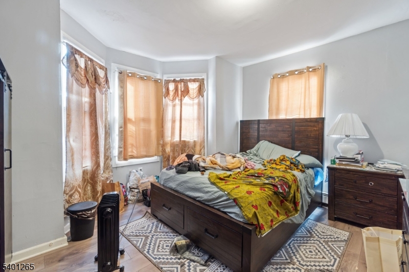 295 South 7th Street Newark, NJ 07103 - Photo 13 of 14 a bed sitting in a bedroom next to a window