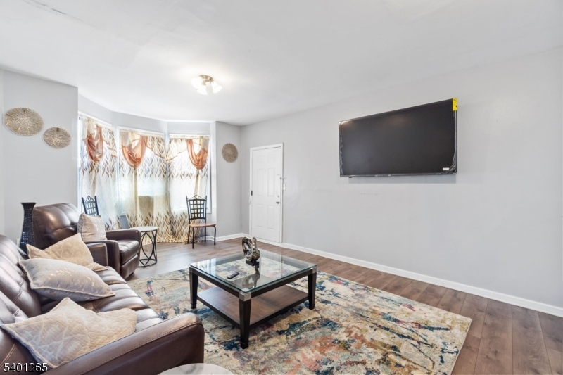 295 South 7th Street Newark, NJ 07103 - Photo 4 of 14 a living room with furniture and a flat screen tv