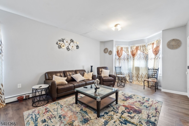 295 South 7th Street Newark, NJ 07103 - Photo 10 of 14 a living room with furniture and a large window