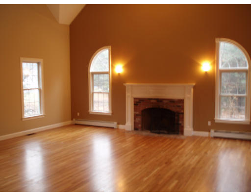 12 Collins Road Berlin, MA 01503 - Photo 9 of 14 a view of empty room with wooden floor and fireplace