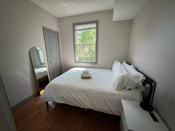 a bedroom with a bed and a window