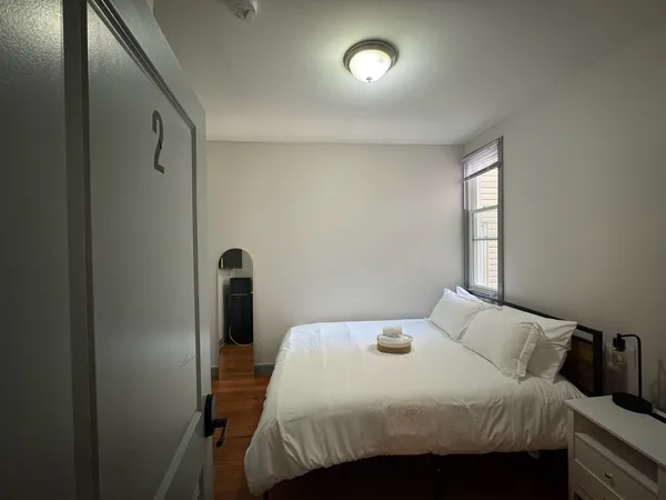 a bedroom with a bed and a window