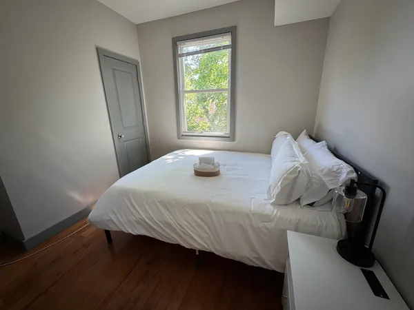 a bedroom with a bed and window