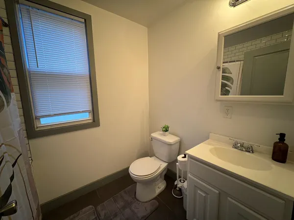 a bathroom with a toilet sink and mirror