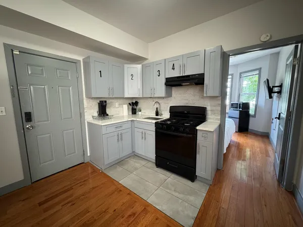 a kitchen with a refrigerator and a stove top oven