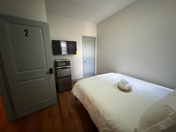 a bedroom with a bed and a tv