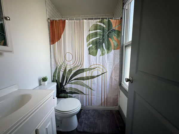 a bathroom with a toilet a sink and tub
