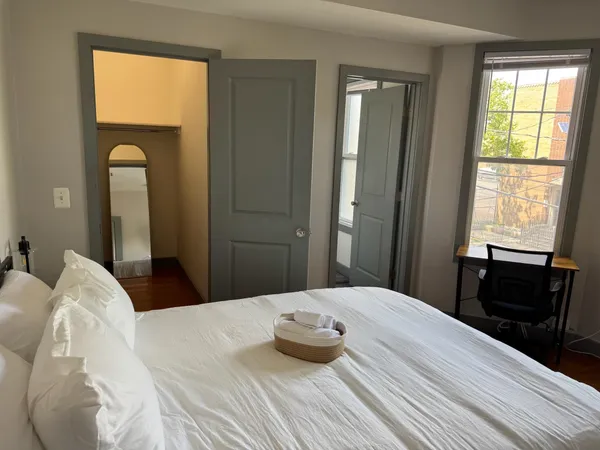 a bedroom with a bed and a dresser