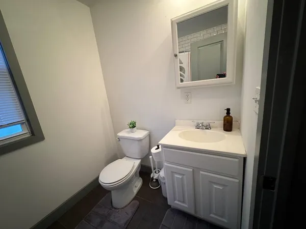 a white toilet sitting next to a bathroom sink