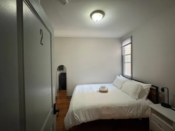 a bedroom with a bed and a window