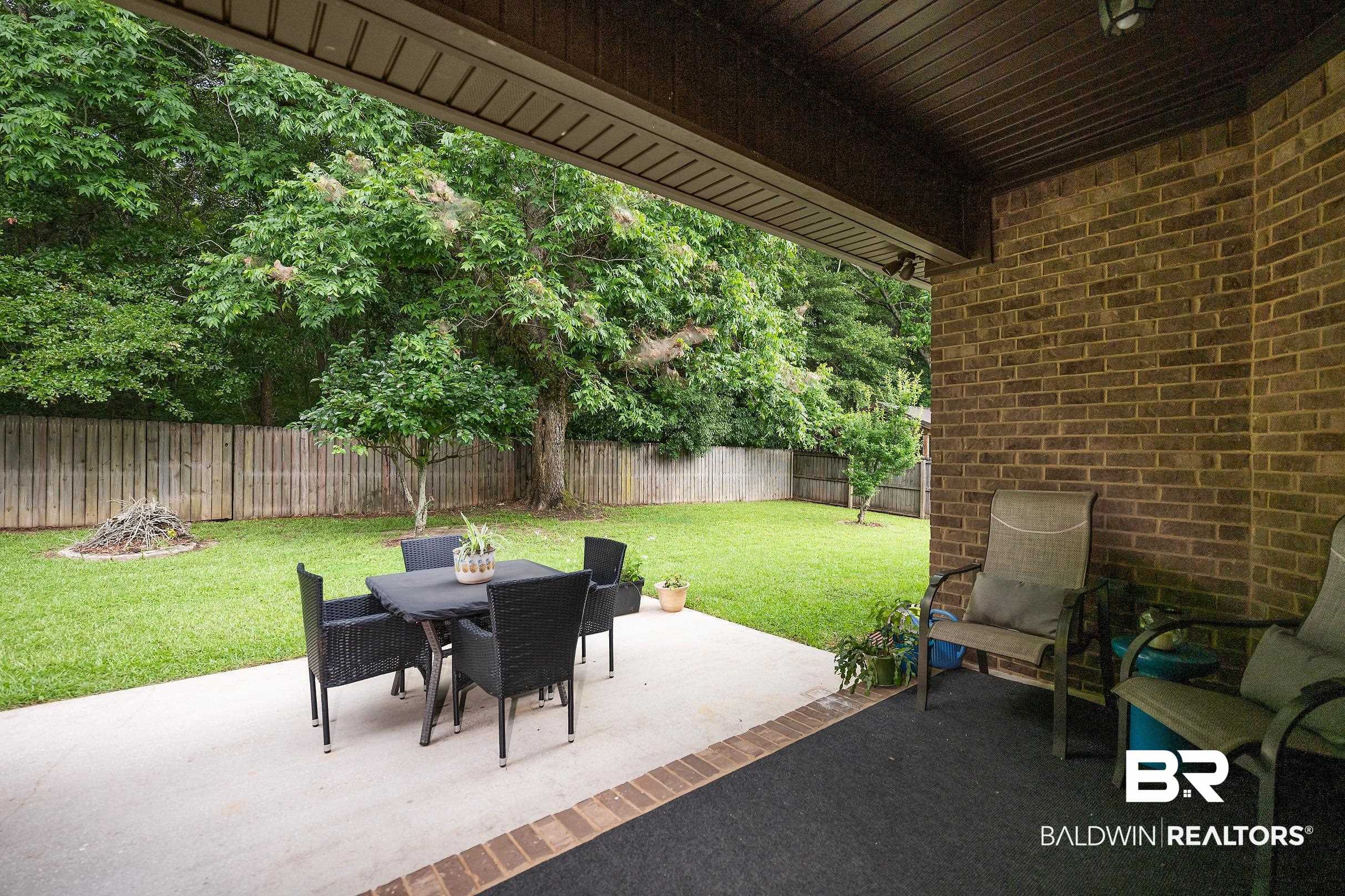 313 Pecan Ridge Boulevard Fairhope, AL 36532 - Photo 33 of 51 Covered patio featuring a brick accent wall and a concrete patio slab
