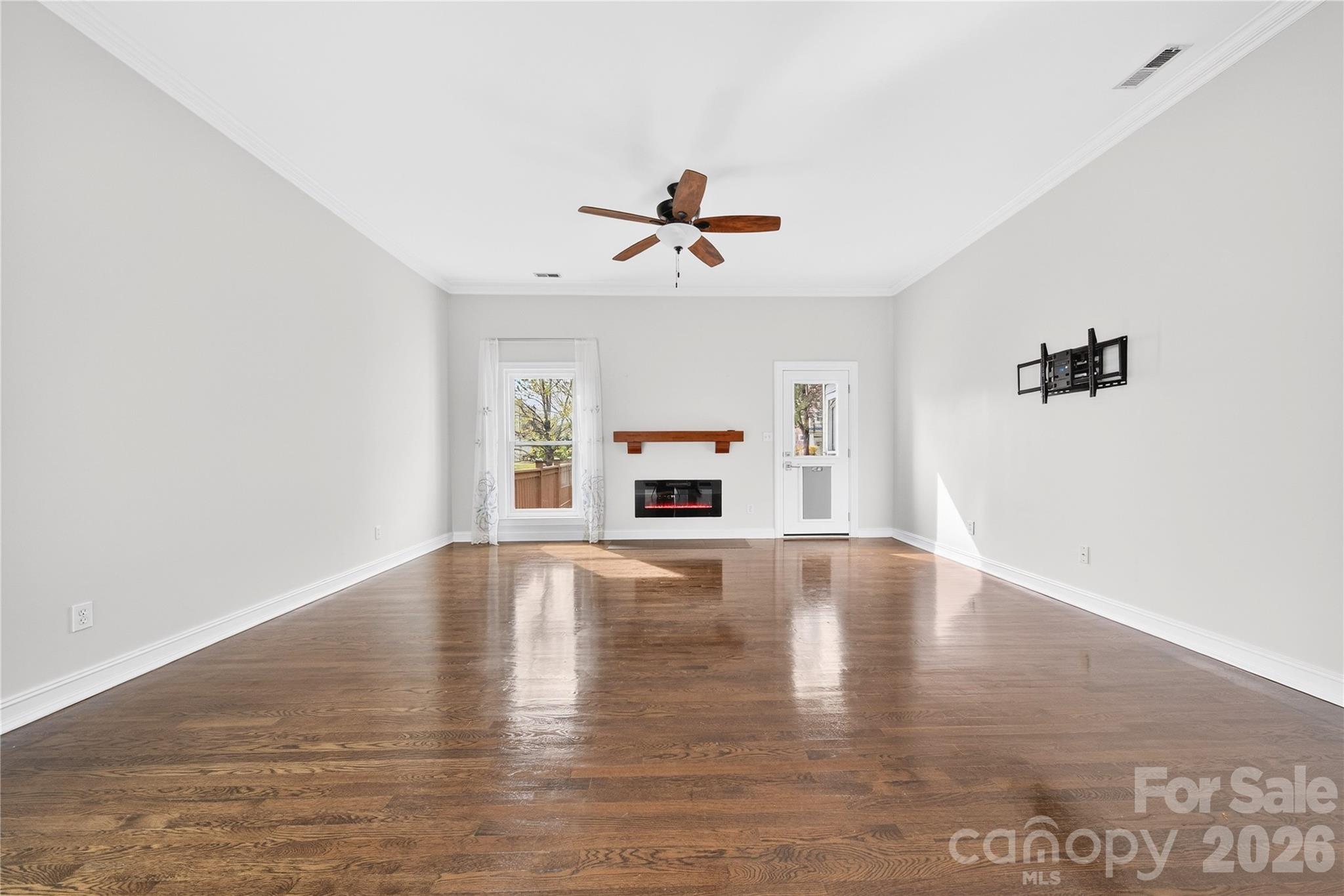20314 Colony Point Lane Cornelius, NC 28031 - Photo 15 of 45 an empty room with windows and fireplace