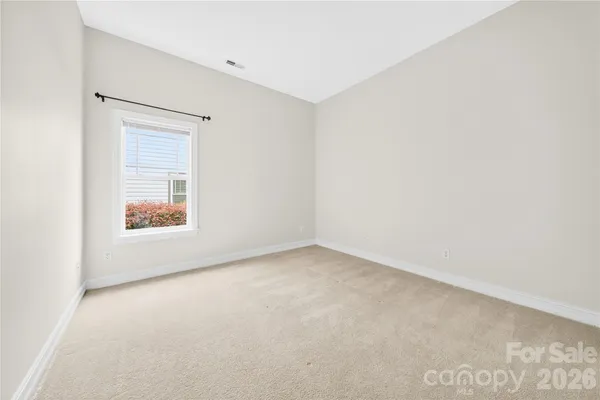 an aerial view of a house with a garden and lake view