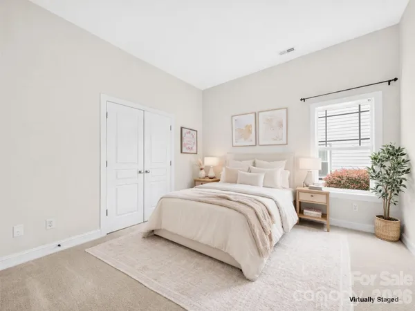 an aerial view of a house with a yard and lake view