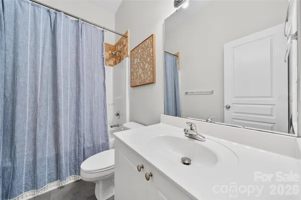 a front view of a house with a yard and potted plants