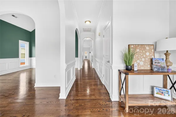 a view of a kitchen with wooden floor and a living room