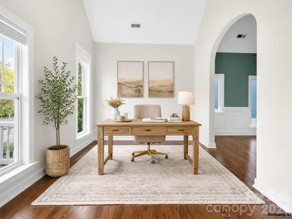 a white kitchen with stainless steel appliances granite countertop a stove a sink dishwasher and a refrigerator
