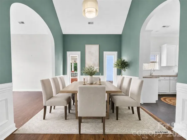 a large kitchen with kitchen island a sink stainless steel appliances and cabinets