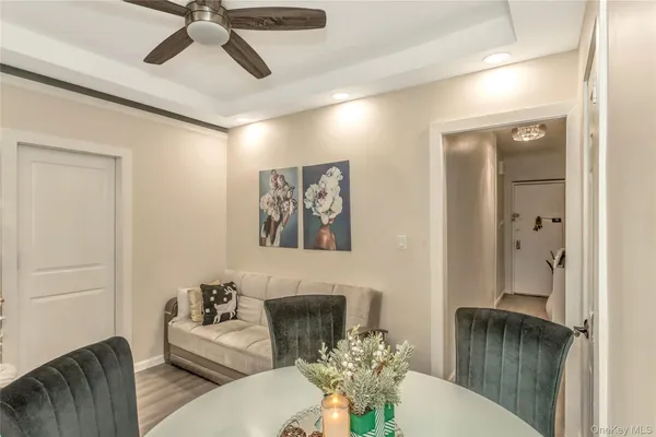 a living room with furniture and a chandelier