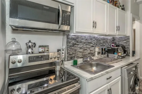 a kitchen with a sink and cabinets