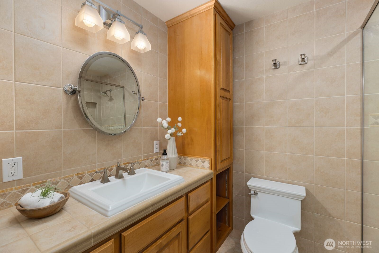 702 Rhodora Heights Road Lake Stevens, WA 98258 - Photo 23 of 40 a bathroom with a sink a toilet and a mirror