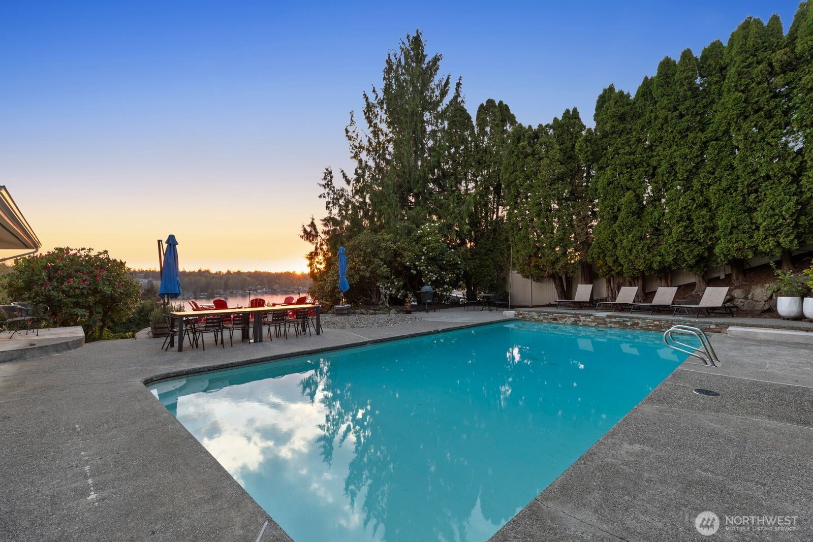 702 Rhodora Heights Road Lake Stevens, WA 98258 - Photo 35 of 40 a view of a swimming pool with a garden and trees