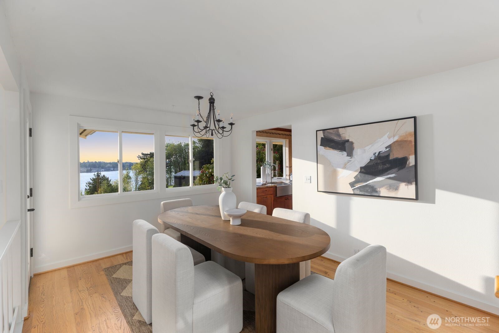 702 Rhodora Heights Road Lake Stevens, WA 98258 - Photo 9 of 40 a view of a dining room with furniture wooden floor and a large window