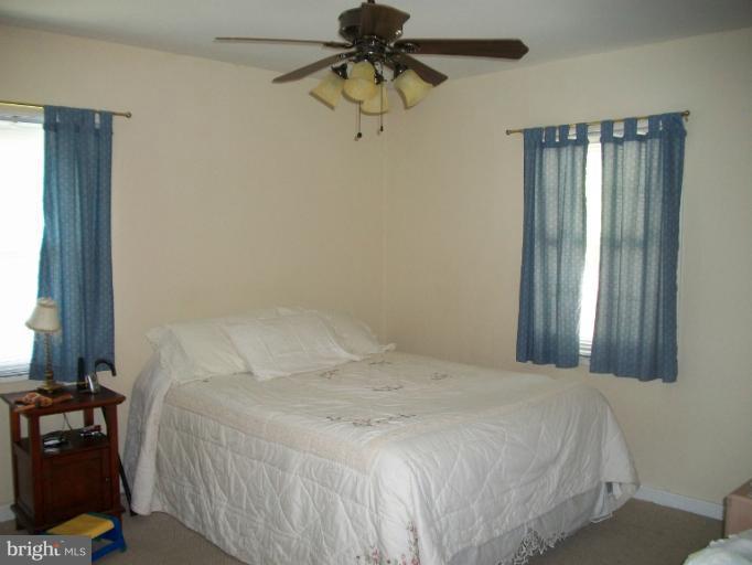 7310 Old Keene Mill Road Springfield, VA 22150 - Photo 2 of 30 a bedroom with a bed and a chandelier