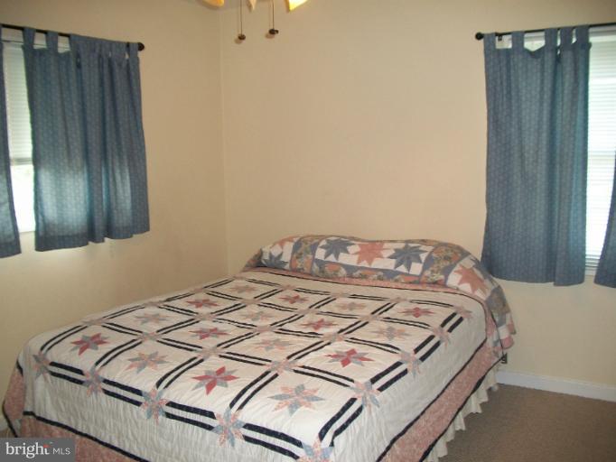 7310 Old Keene Mill Road Springfield, VA 22150 - Photo 11 of 30 a bedroom with a bed and a cabinets