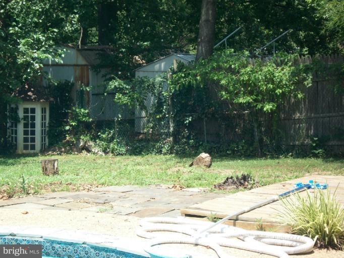 7310 Old Keene Mill Road Springfield, VA 22150 - Photo 12 of 30 a backyard of a house with a yard and outdoor seating