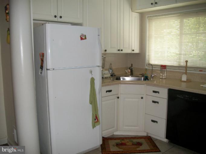 7310 Old Keene Mill Road Springfield, VA 22150 - Photo 16 of 30 a white refrigerator freezer sitting inside of a kitchen