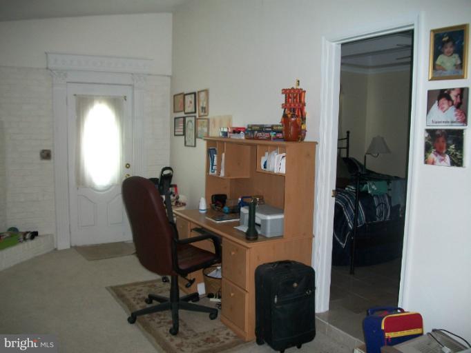 7310 Old Keene Mill Road Springfield, VA 22150 - Photo 18 of 30 a view of a workspace with furniture and a potted plant