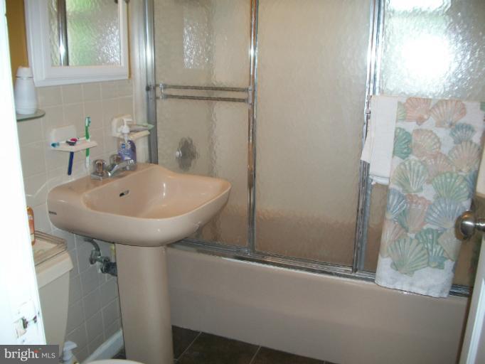7310 Old Keene Mill Road Springfield, VA 22150 - Photo 3 of 30 a bathroom with a sink and mirror