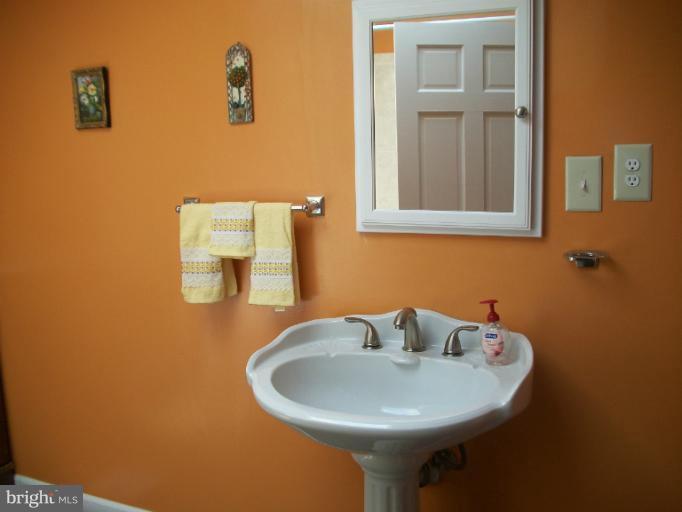 7310 Old Keene Mill Road Springfield, VA 22150 - Photo 28 of 30 a bathroom with a sink and a mirror