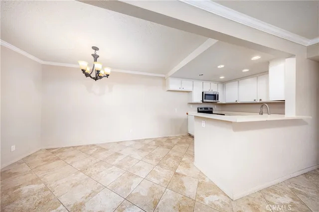 a view of kitchen with center island and stainless steel appliances