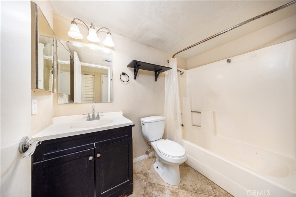 21 Country Mile Road Pomona, CA 91766 - Photo 10 of 18 a bathroom with a sink a toilet a mirror and shower