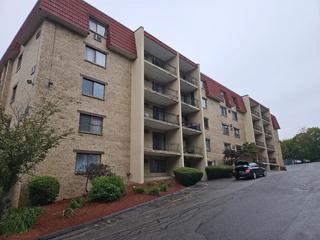 a tall brick building with a clock on the side of it