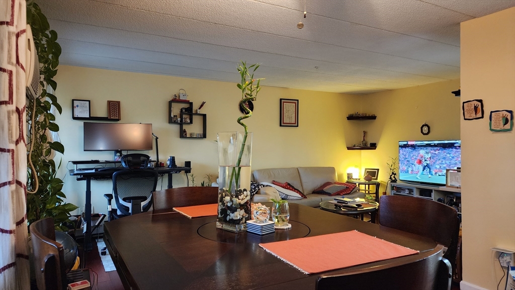 157 Franklin Street, Unit D1 Stoneham, MA 02180 - Photo 2 of 16 a room with furniture and a flat screen tv