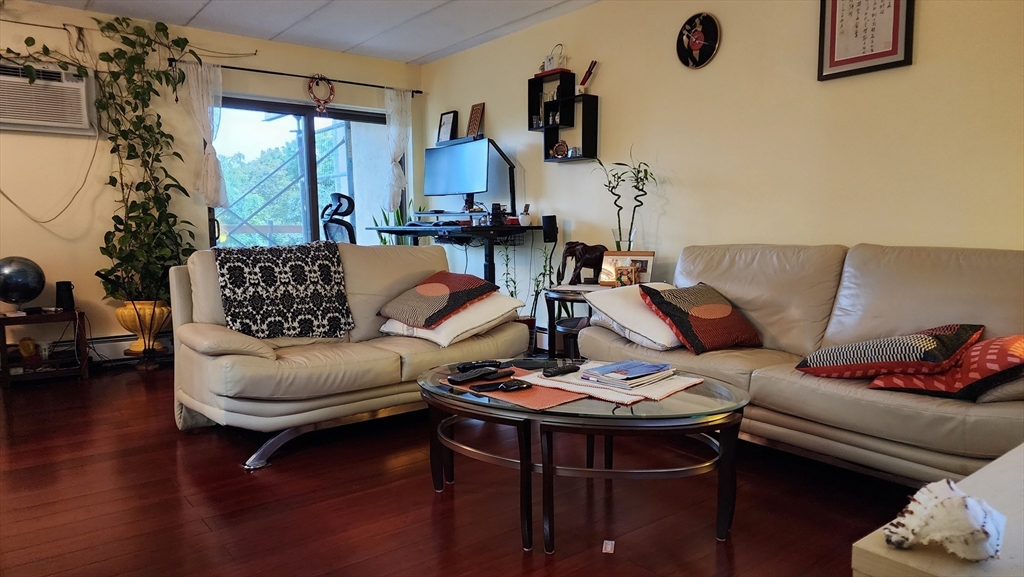 157 Franklin Street, Unit D1 Stoneham, MA 02180 - Photo 5 of 16 a living room with furniture and a window