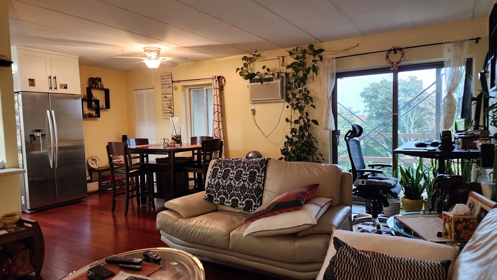 157 Franklin Street, Unit D1 Stoneham, MA 02180 - Photo 7 of 16 a living room with furniture and a large window