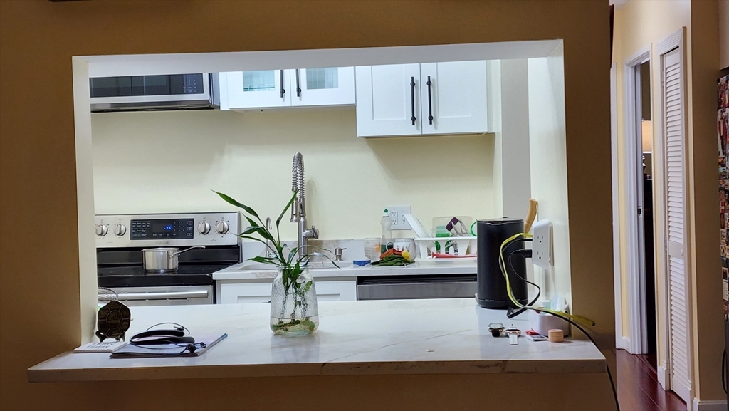157 Franklin Street, Unit D1 Stoneham, MA 02180 - Photo 10 of 16 a view of kitchen appliances and cabinets
