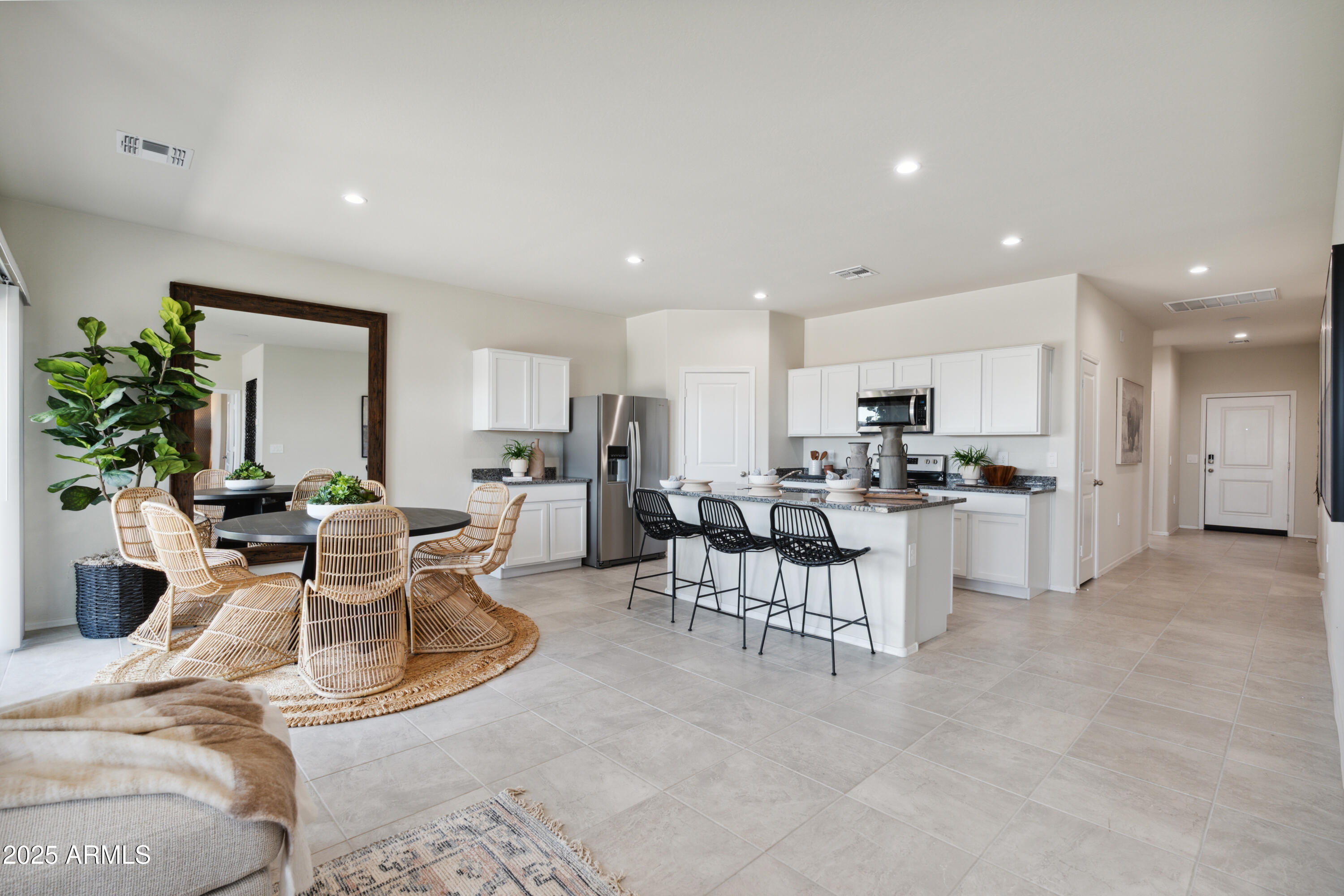 1426 East Bealey Avenue Coolidge, AZ 85128 - Photo 3 of 27 a living room with furniture and a dining table with kitchen view