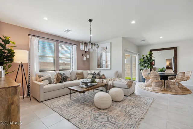 a living room with furniture and a chandelier