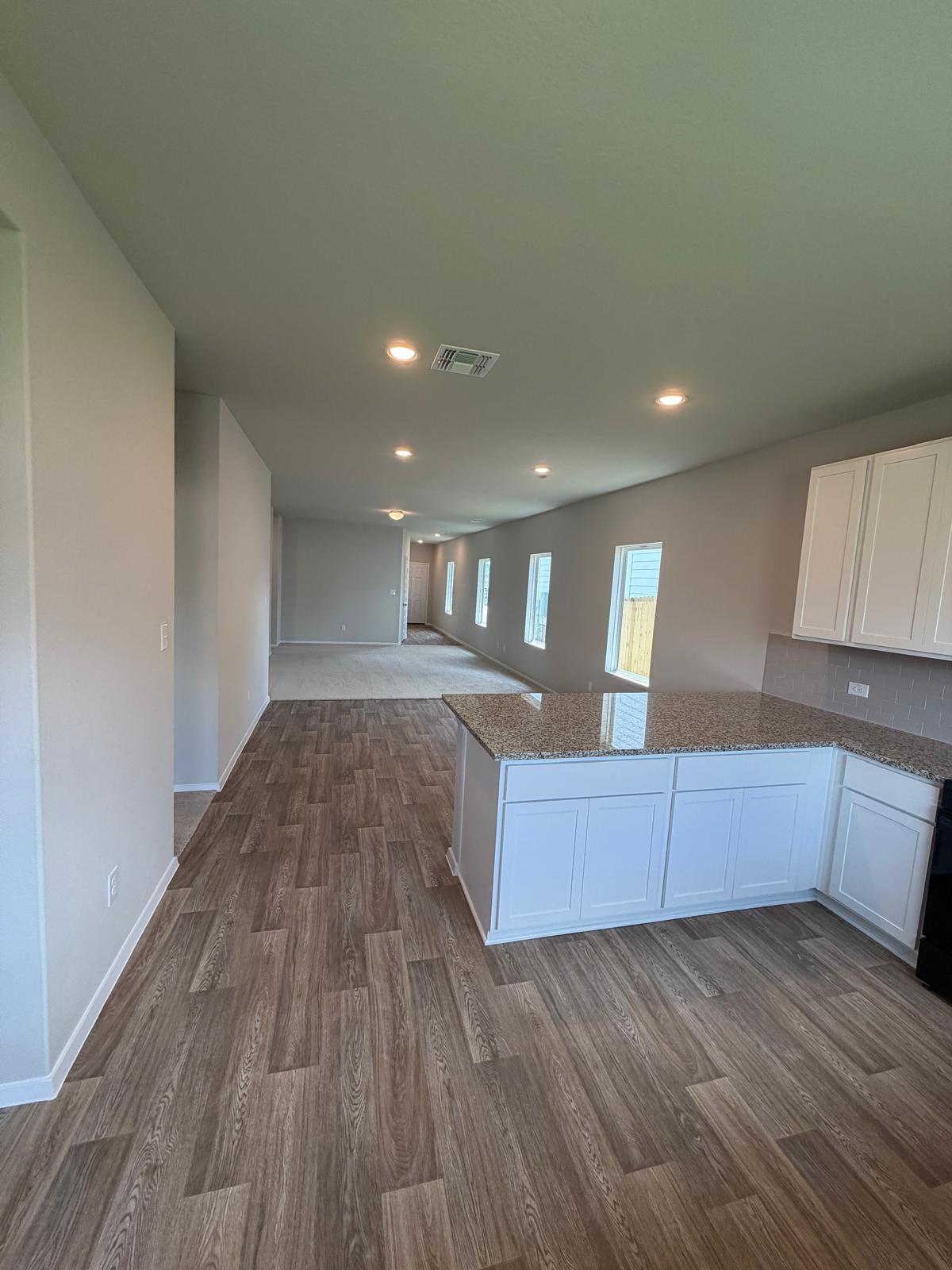 2612 Towy Road Manor, TX 78653 - Photo 23 of 35 An open-concept living space highlights a well-lit kitchen island, ideal for entertaining.