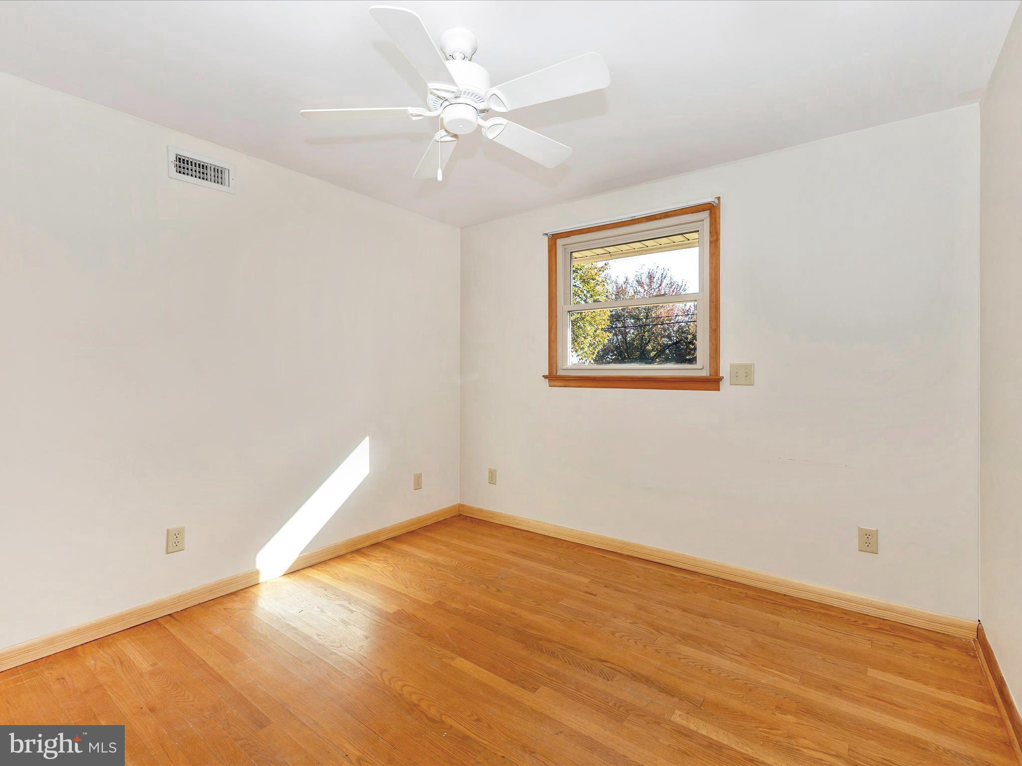3300 Harney Road Taneytown, MD 21787 - Photo 25 of 37 an empty room with wooden floor and window