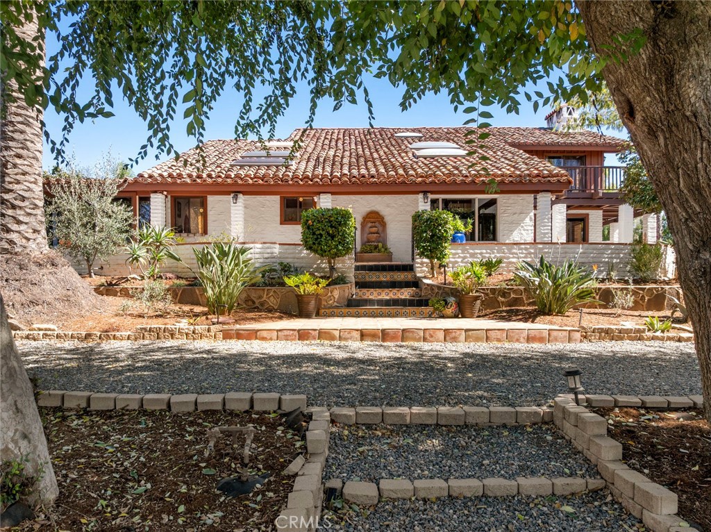 11550 Old Castle Road Valley Center, CA 92082 - Photo 2 of 74 a front view of a house with garden