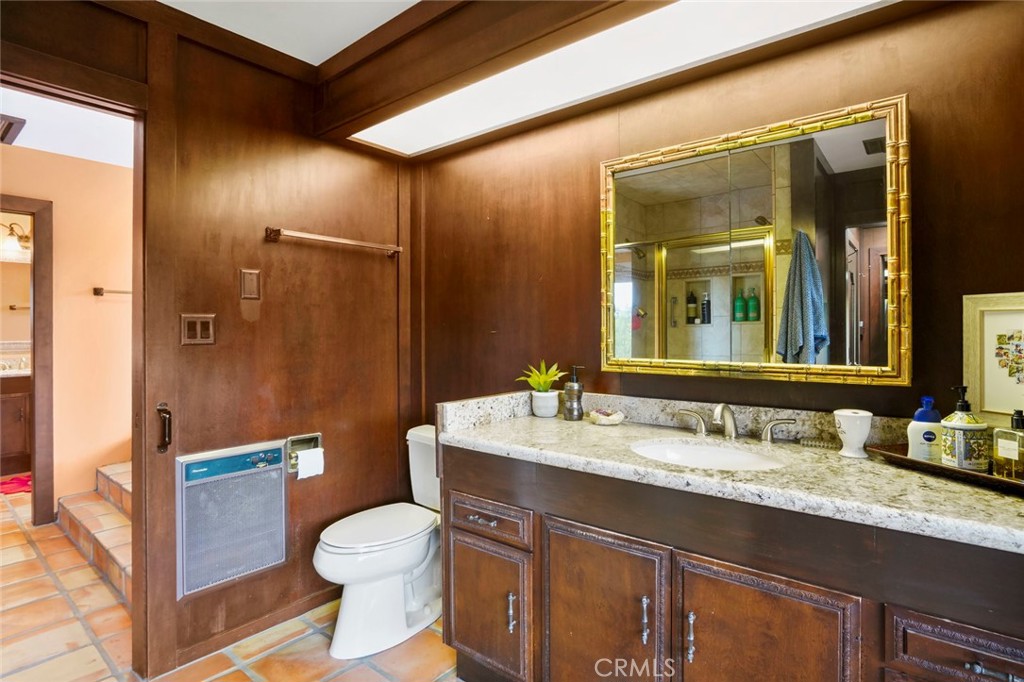 11550 Old Castle Road Valley Center, CA 92082 - Photo 28 of 74 a bathroom with a granite countertop sink toilet and shower